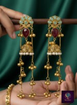 Pink and green floral long dangler jhumka earrings with gold finish, pearl detailing and ghungroo chains.
