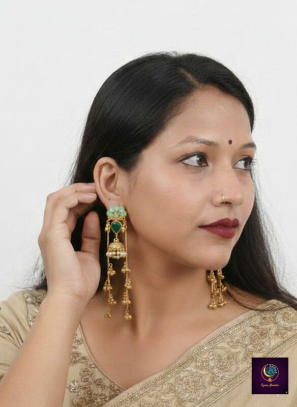 Antique gold finish long jhumka earrings with green stones, pearl detailing and dangling ghungroo chains, anti-tarnish artificial ethnic jewelry for women