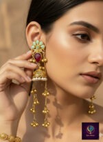 Pink and green floral long dangler jhumka earrings with gold finish, pearl detailing and ghungroo chains.